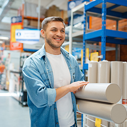 Male consumer buying wallpapers in hardware store